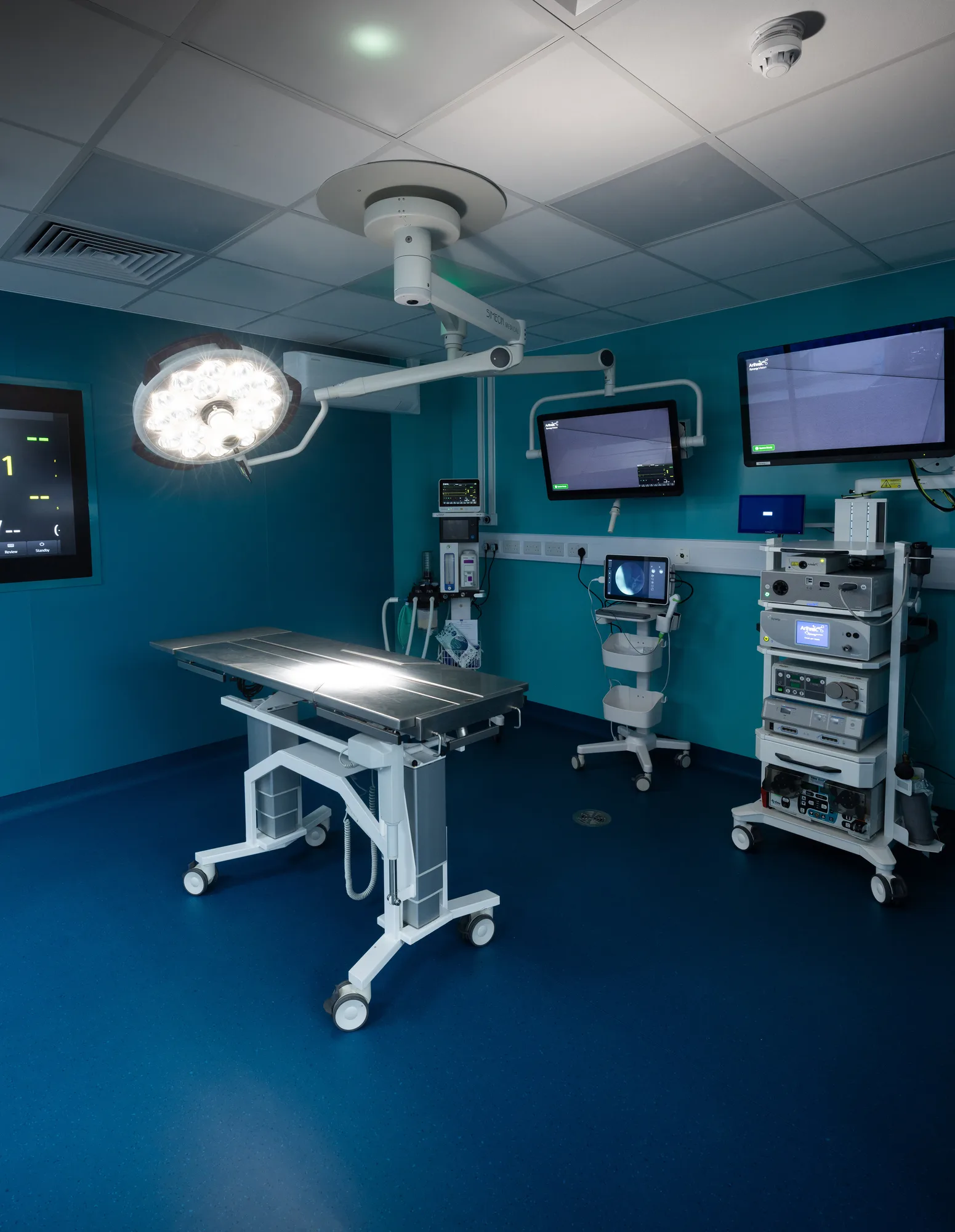 Ceiling pendant arm and surgical light at Vetemis Referrals, Brownhills, with the supply diffuser, monitor arms and wall services trunking
