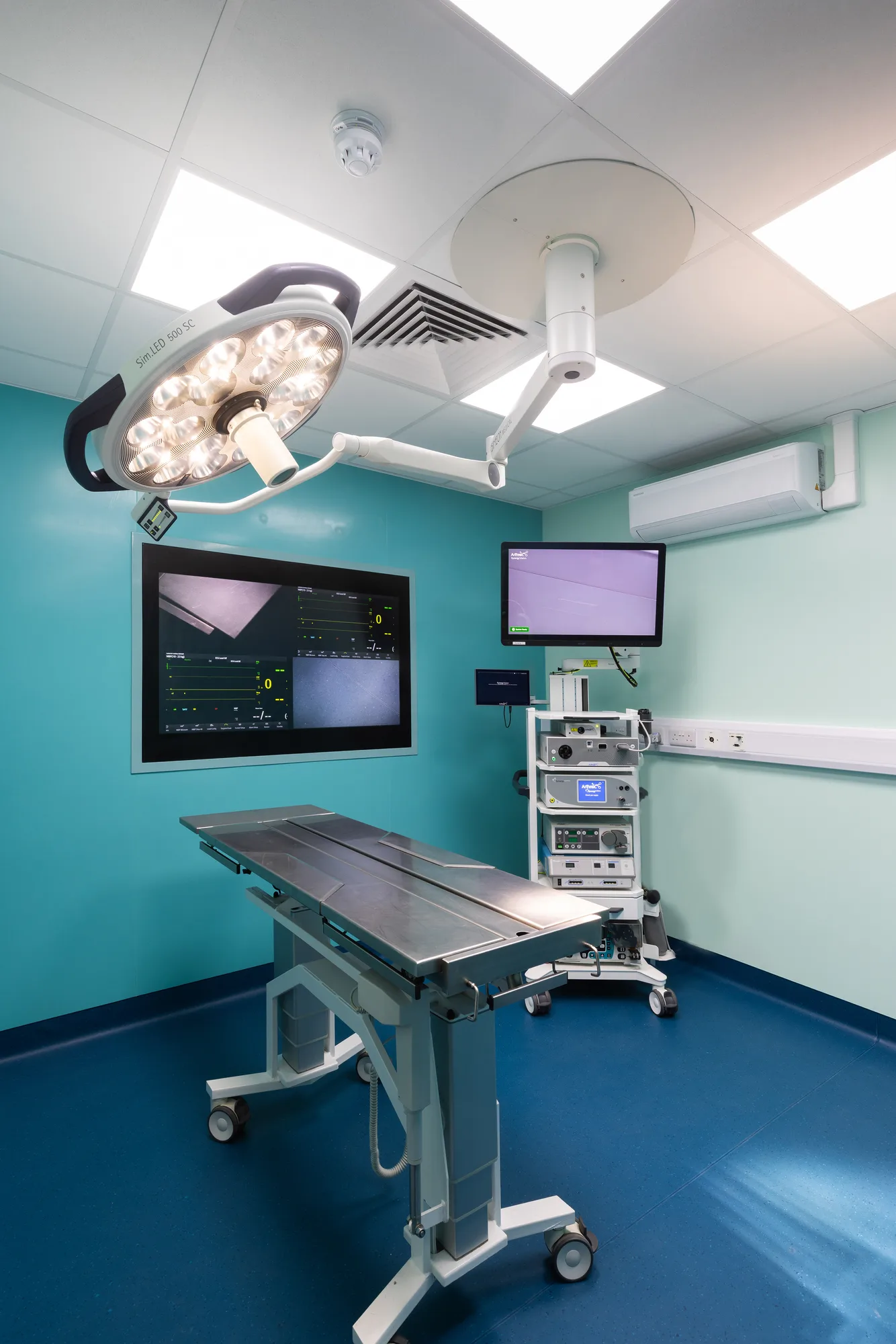Theatre ceiling at Vetemis Referrals, Brownhills, with the surgical light, pendant arm, supply diffuser and recessed panel lighting above the table
