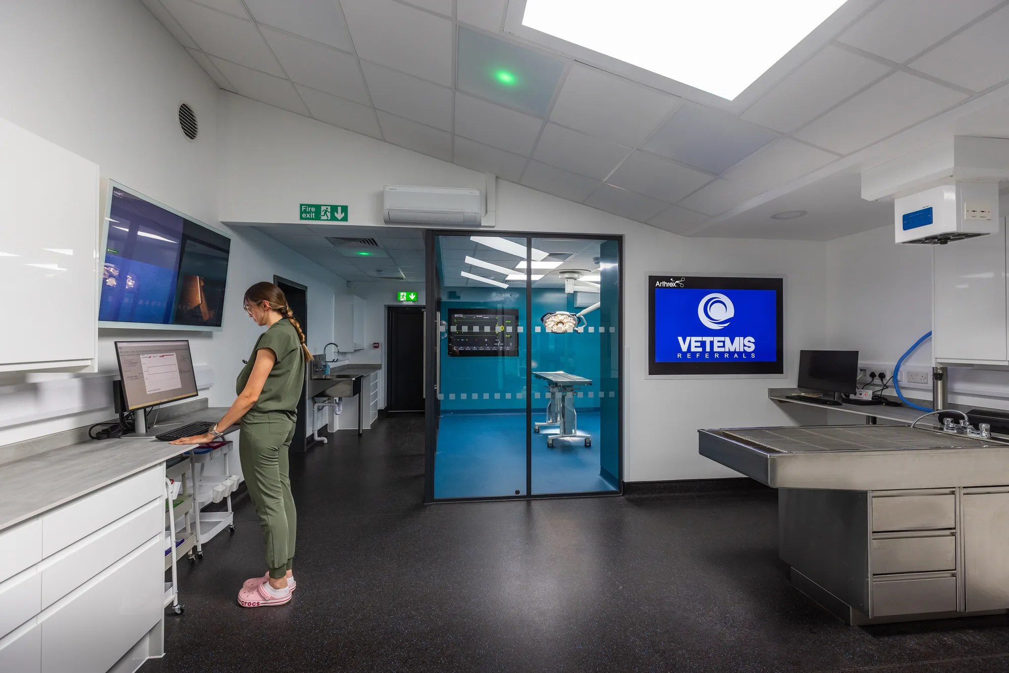 Prep room at Vetemis Referrals, Brownhills, with the clinical workstation, wet prep table and glazed doors through to the theatre