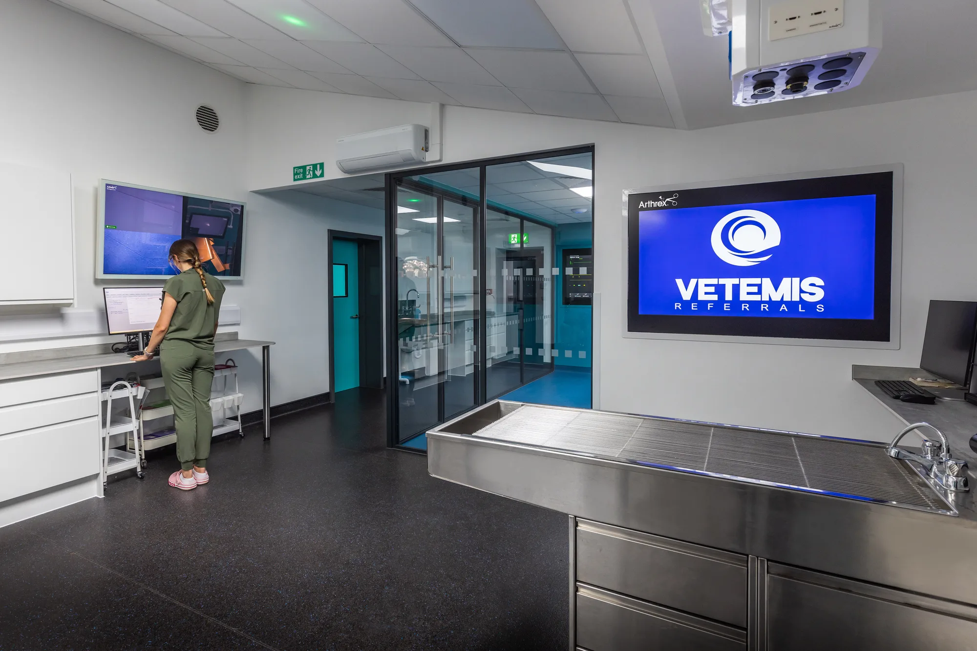 Prep room at Vetemis Referrals, Brownhills, with stainless steel tables and glazed doors to the theatre suite