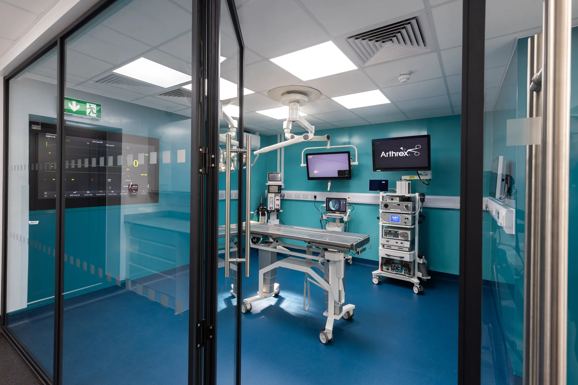 Glazed double doors into the operating theatre at Vetemis Referrals, Brownhills, with manifestation banding and the theatre beyond