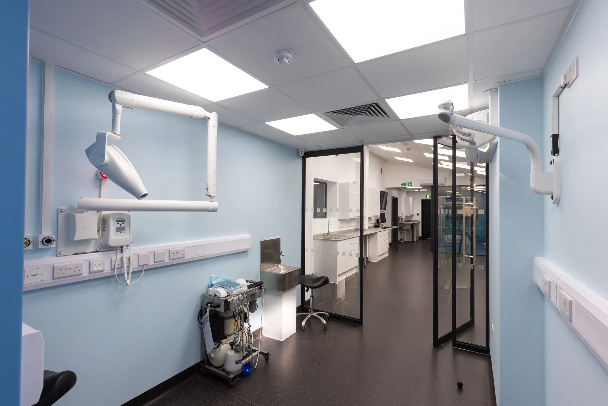 Treatment room at Vetemis Referrals, Brownhills, with wall-mounted imaging arm and glazed partition